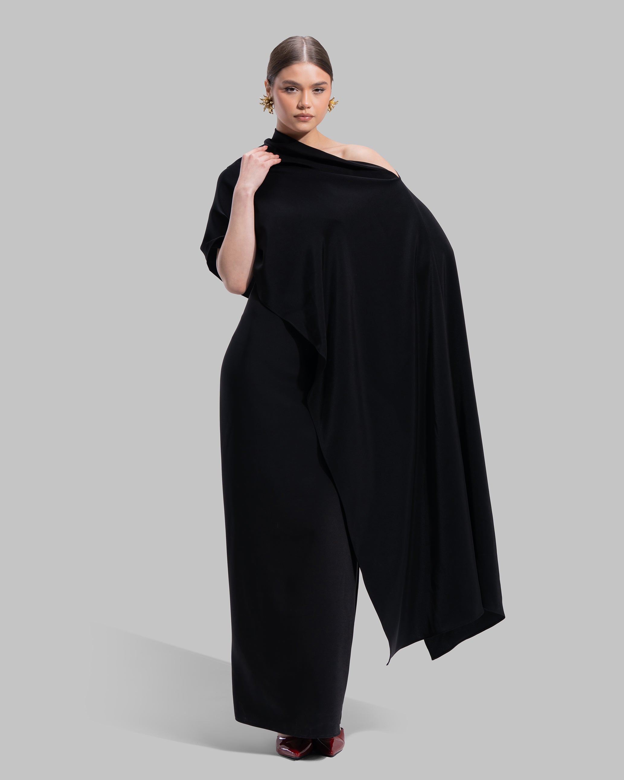 Draped asymmetrical neckline satin maxi dress with a fluid oversized silhouette.