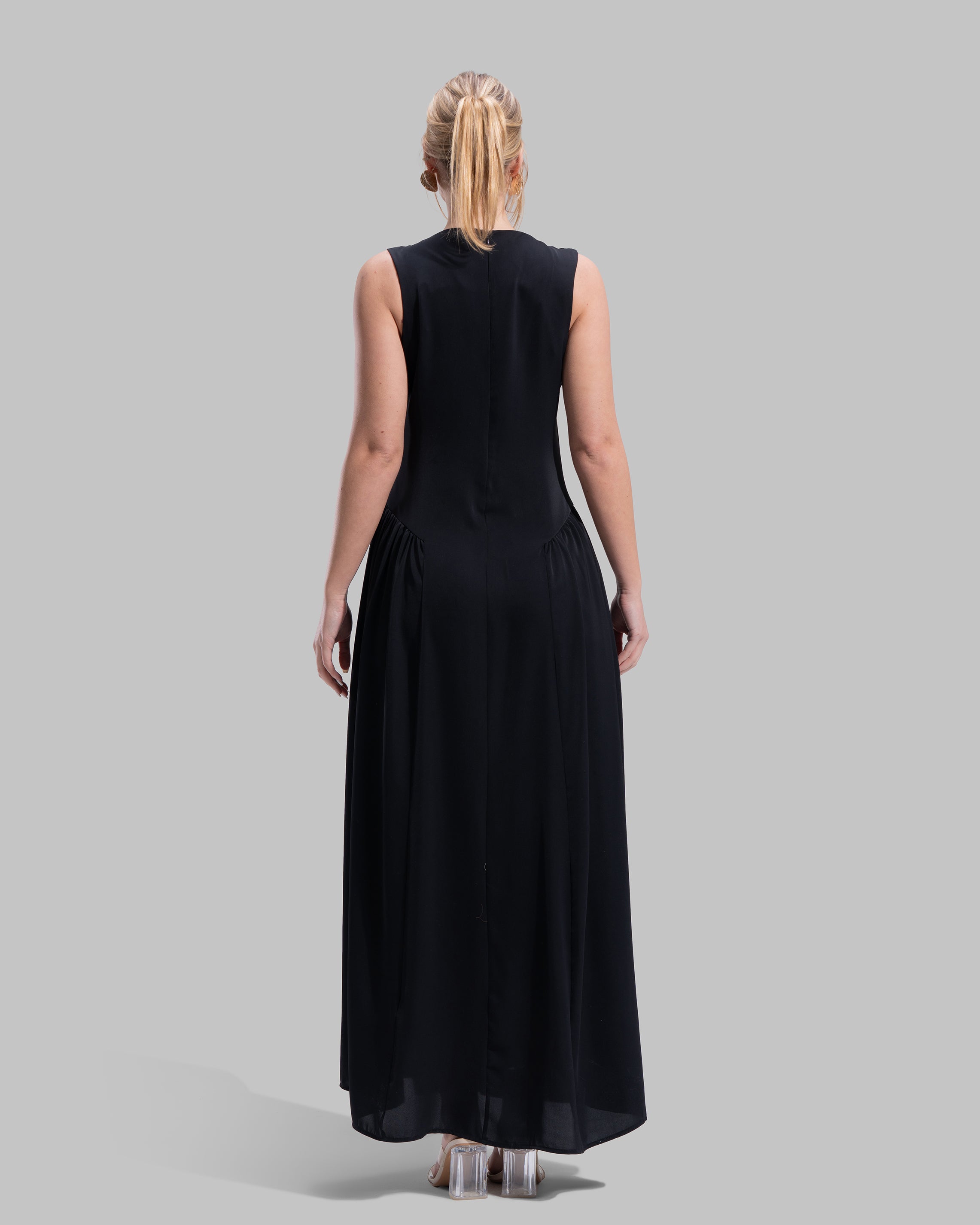 Sleeveless long dress with a round neckline.