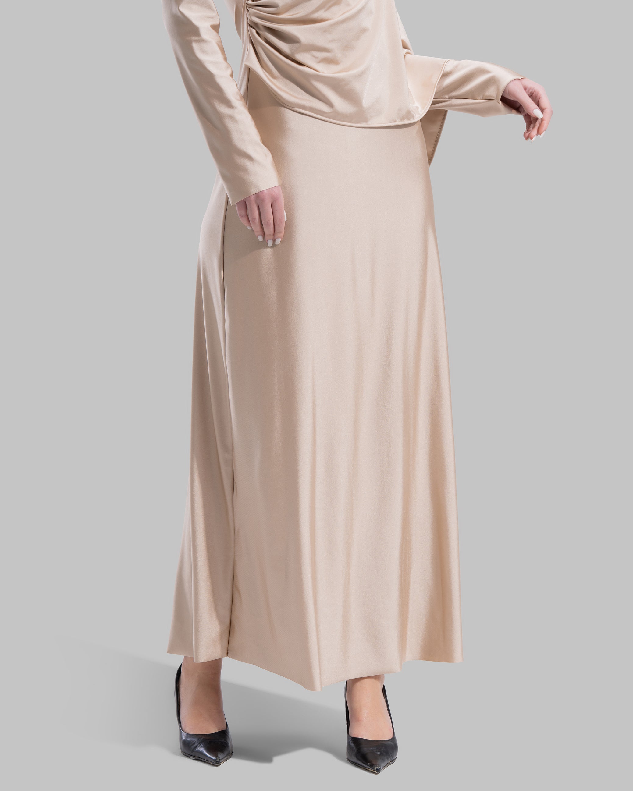 Long draped dress with a round neckline and asymmetrical overlay detail.