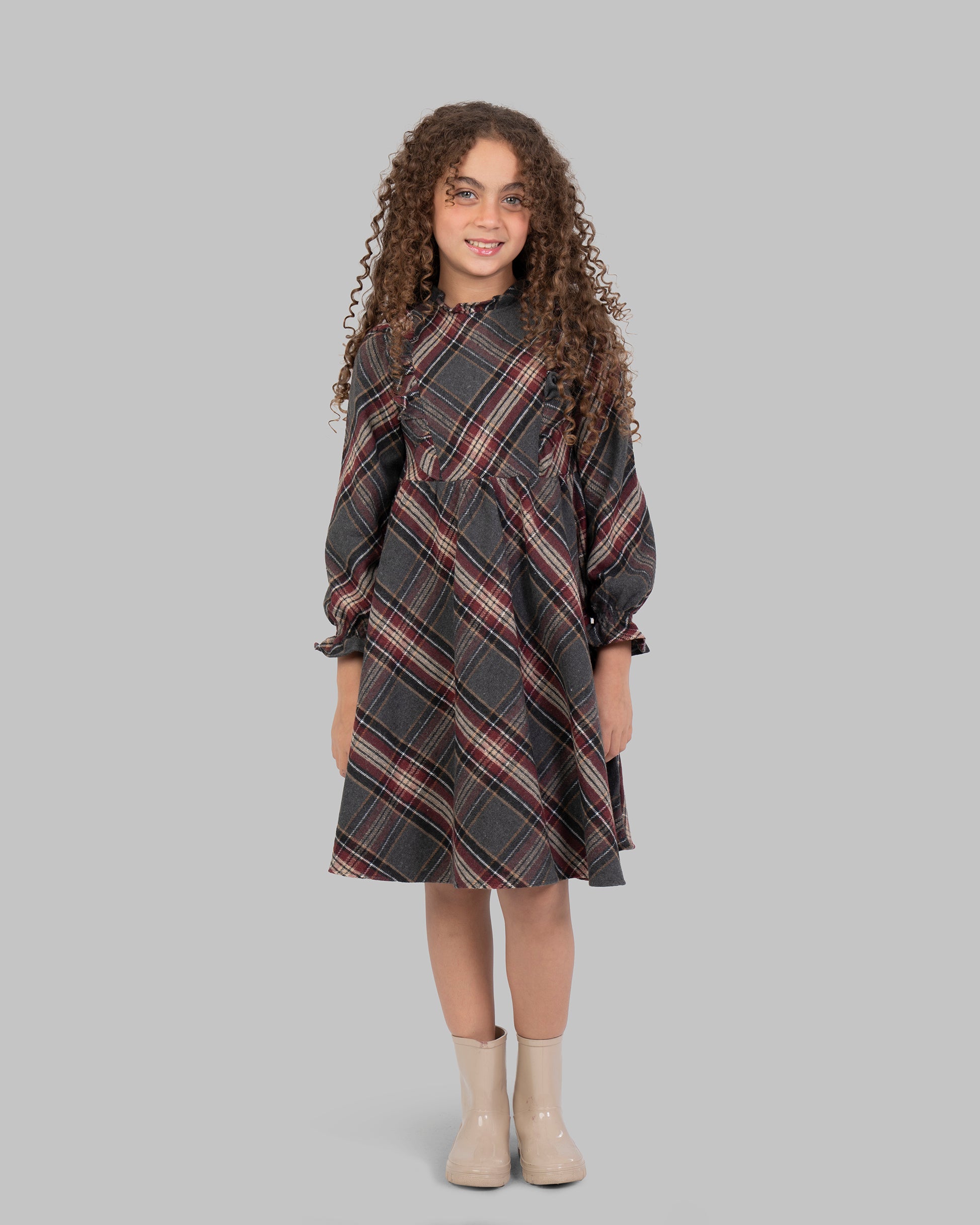Knee-length plaid dress, with long sleeves.