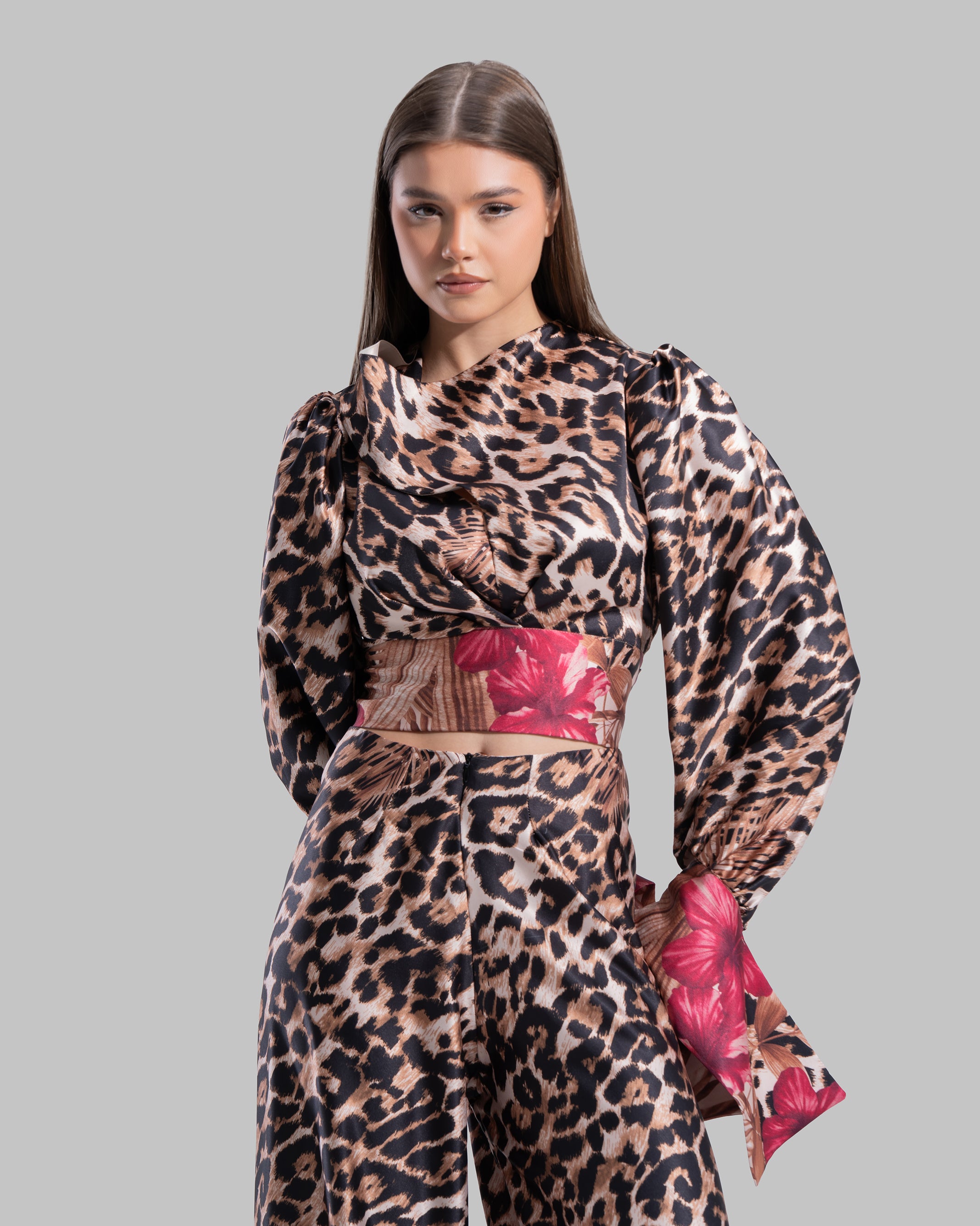 Long sleeve top with a draped neckline and slightly puffed shoulders.