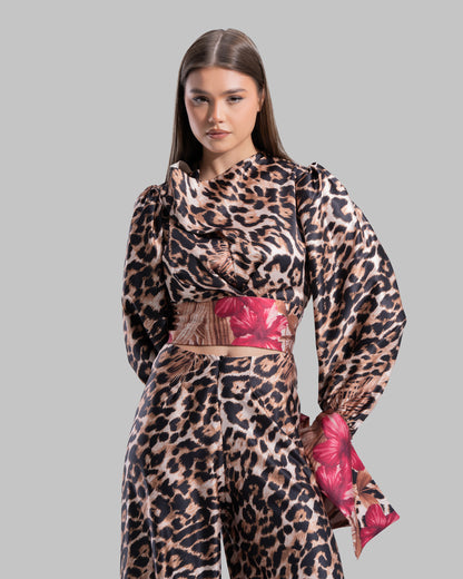 Long sleeve top with a draped neckline and slightly puffed shoulders.