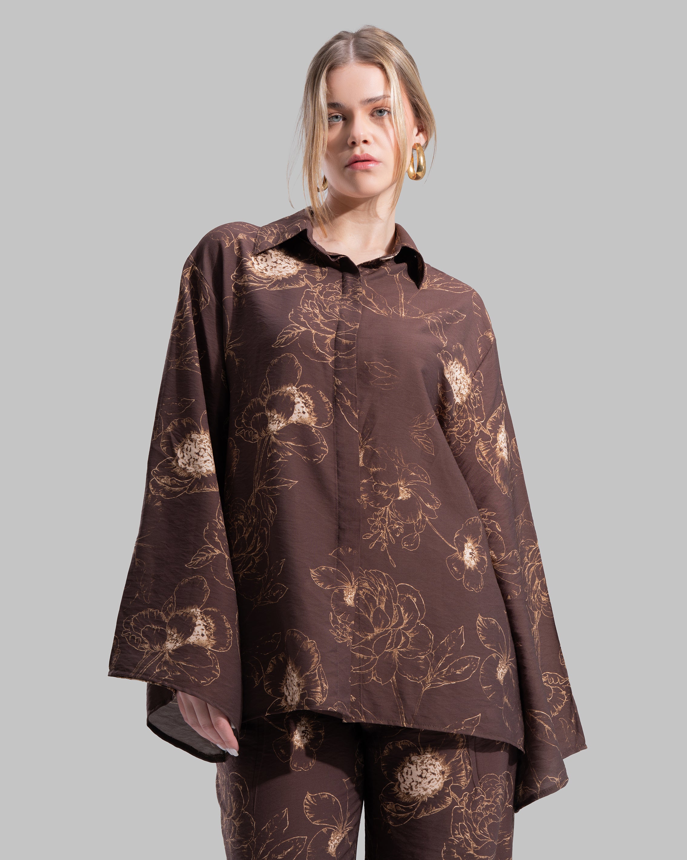 Oversized floral print blouse with a classic collar and long sleeves.