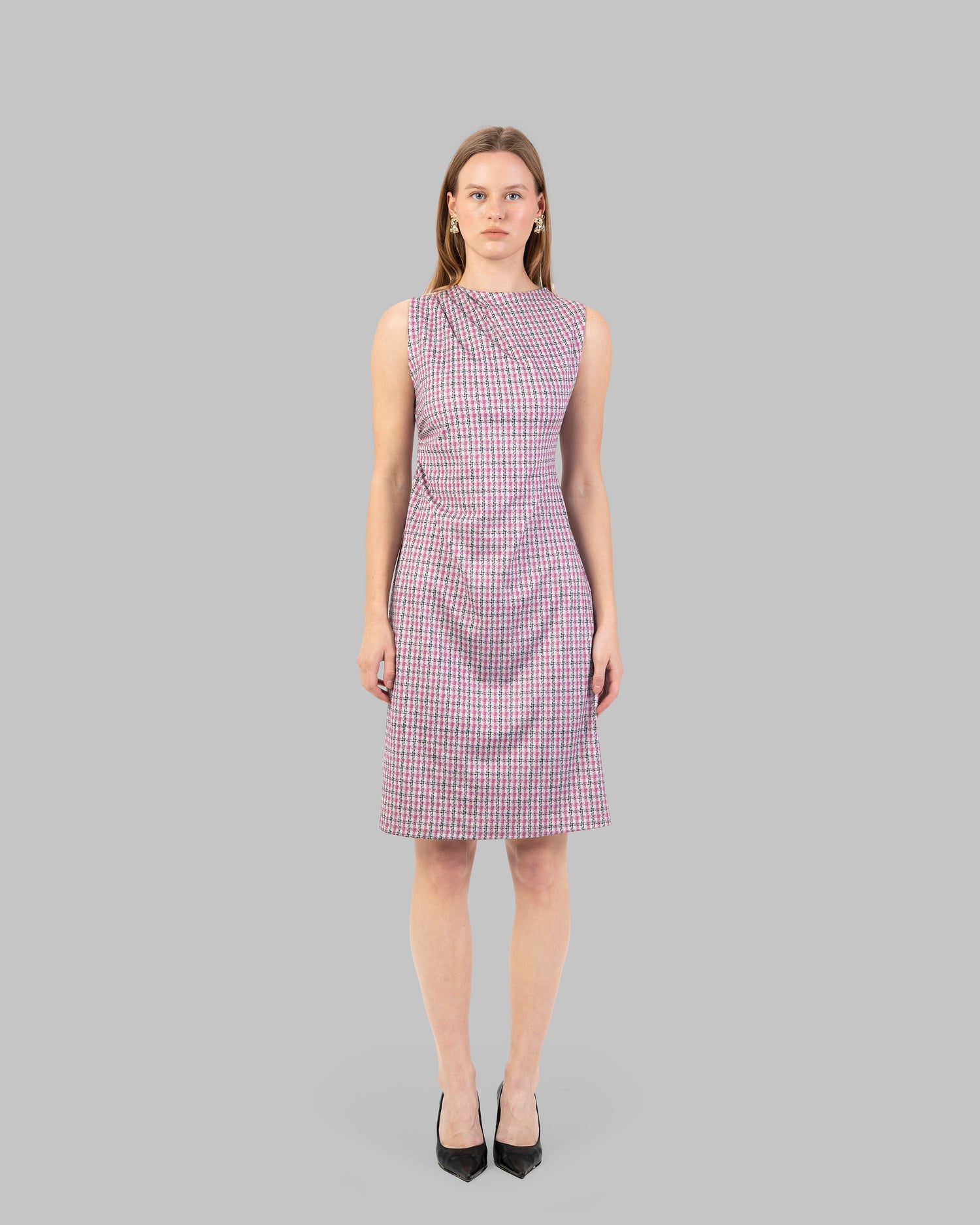 fitted dress with a pink and black houndstooth pattern.