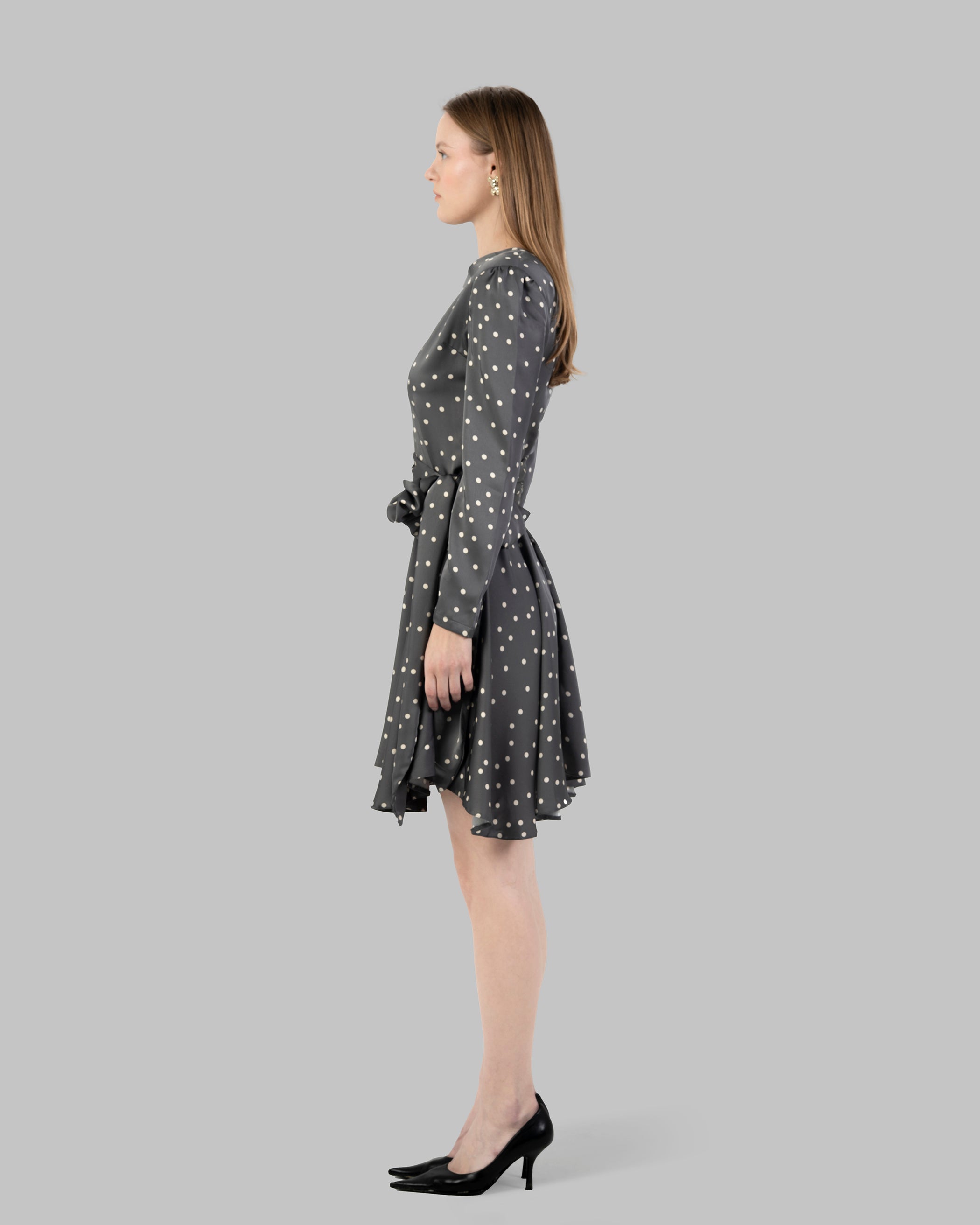A chic polka dot mini dress with long sleeves and a stylish wrap-around tie waist