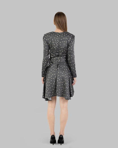 A chic polka dot mini dress with long sleeves and a stylish wrap-around tie waist