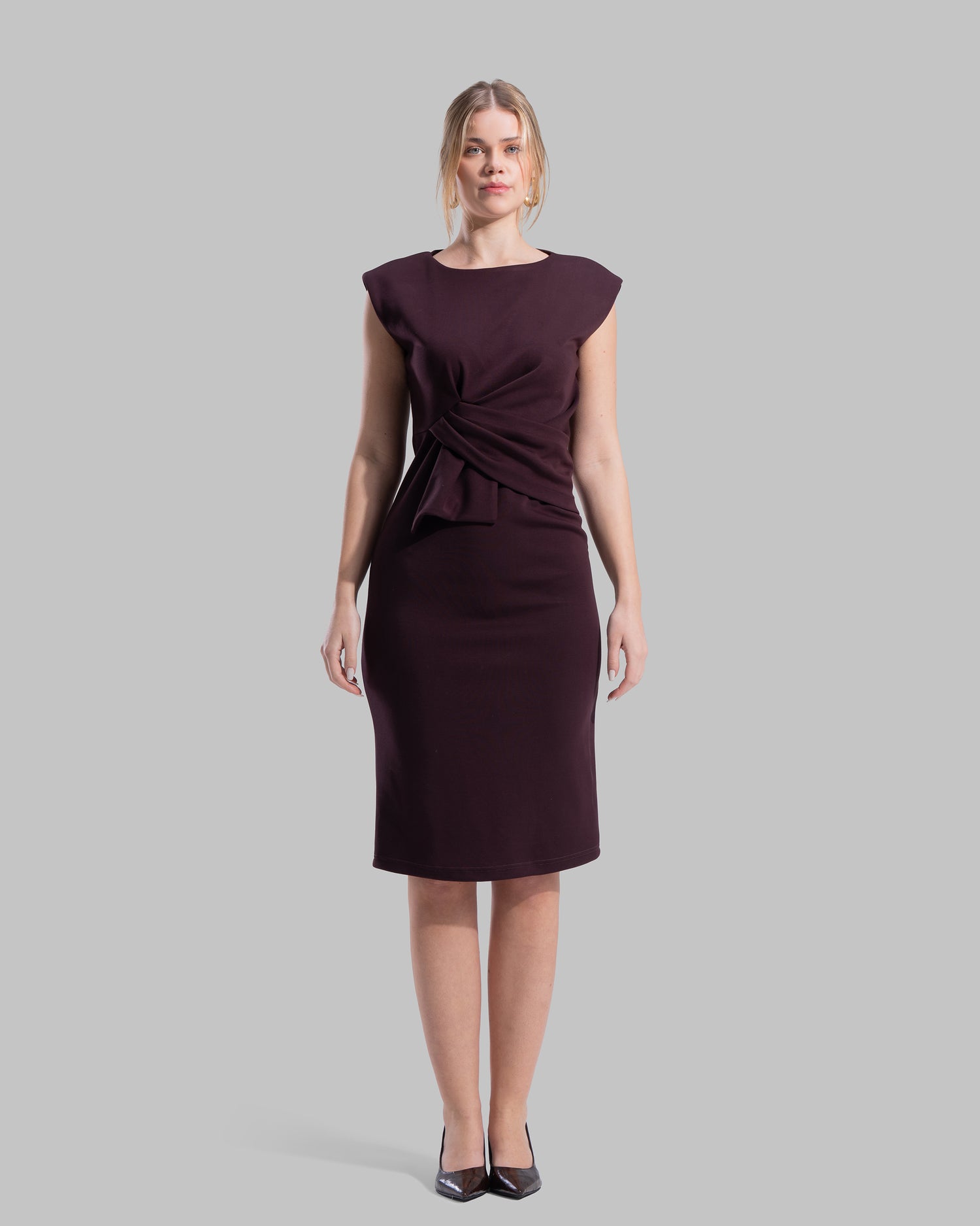 Sleeveless midi dress featuring a round neckline and front draped knot detail.