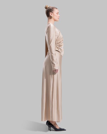 Long draped dress with a round neckline and asymmetrical overlay detail.