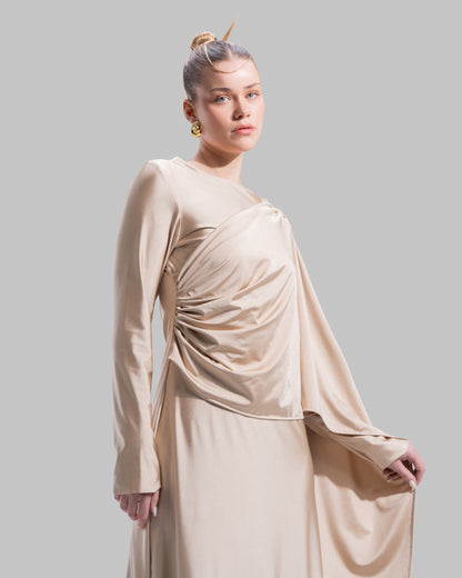 Long draped dress with a round neckline and asymmetrical overlay detail.