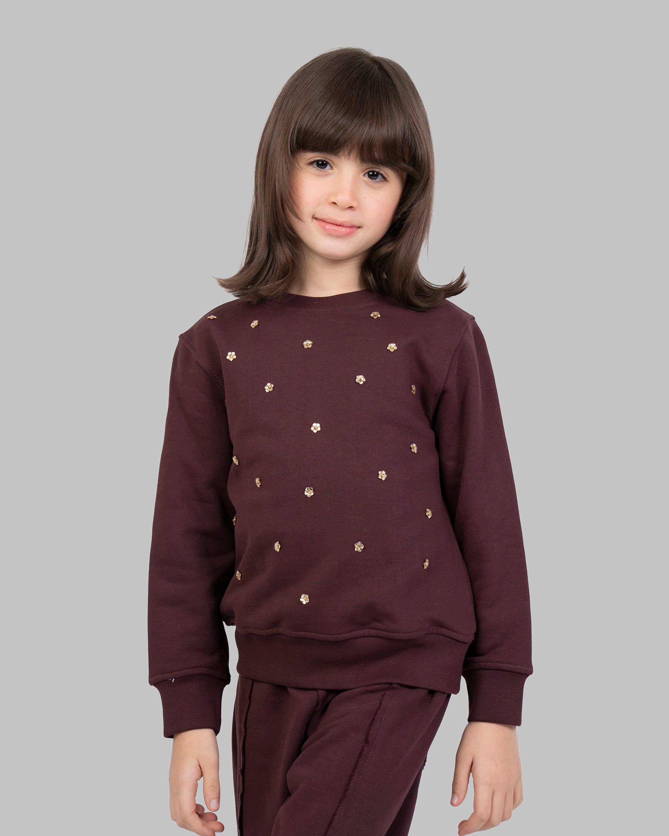 sweatshirt with small, scattered gold flowers on the front.