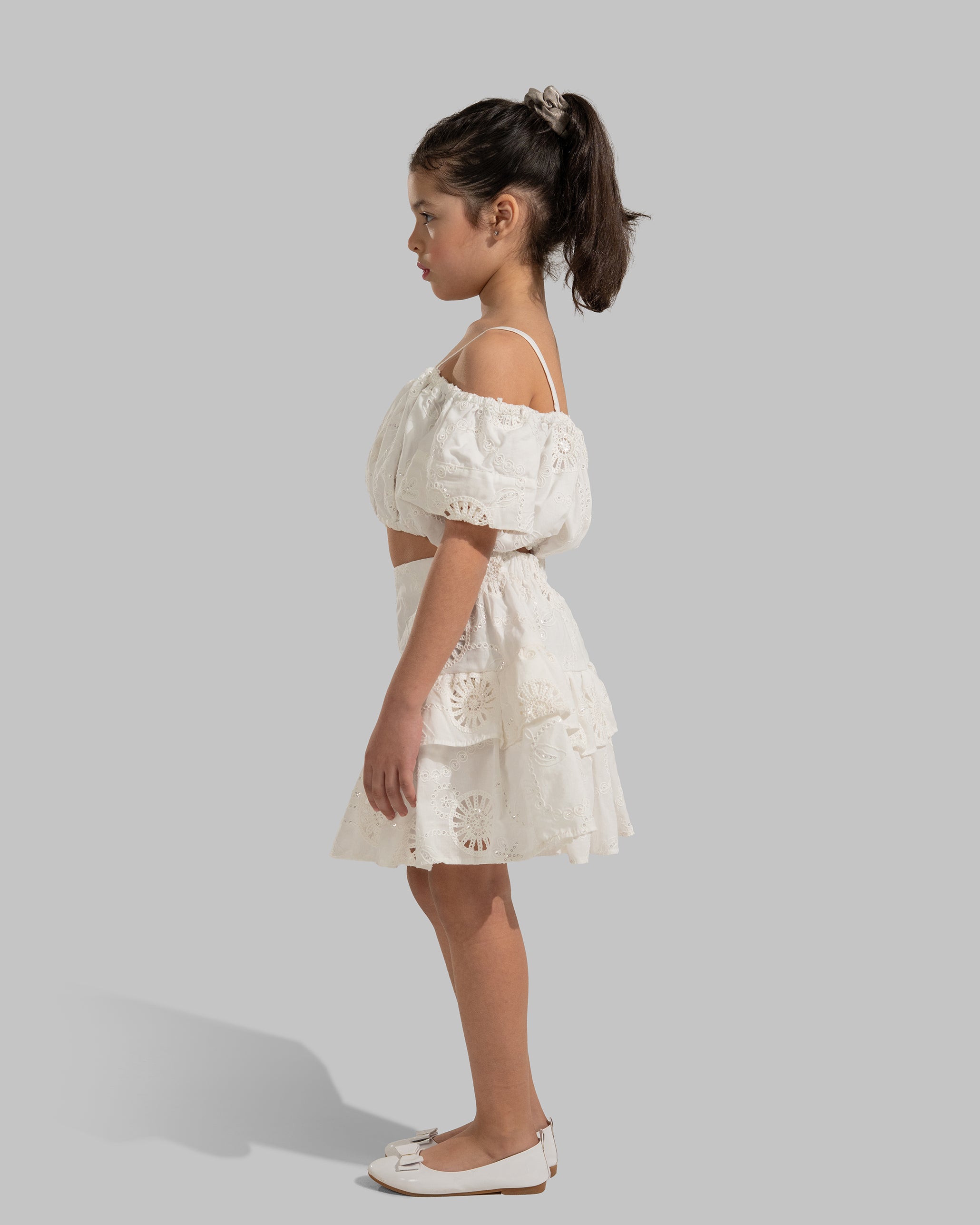 Layered white eyelet mini skirt with a ruffled hem.
