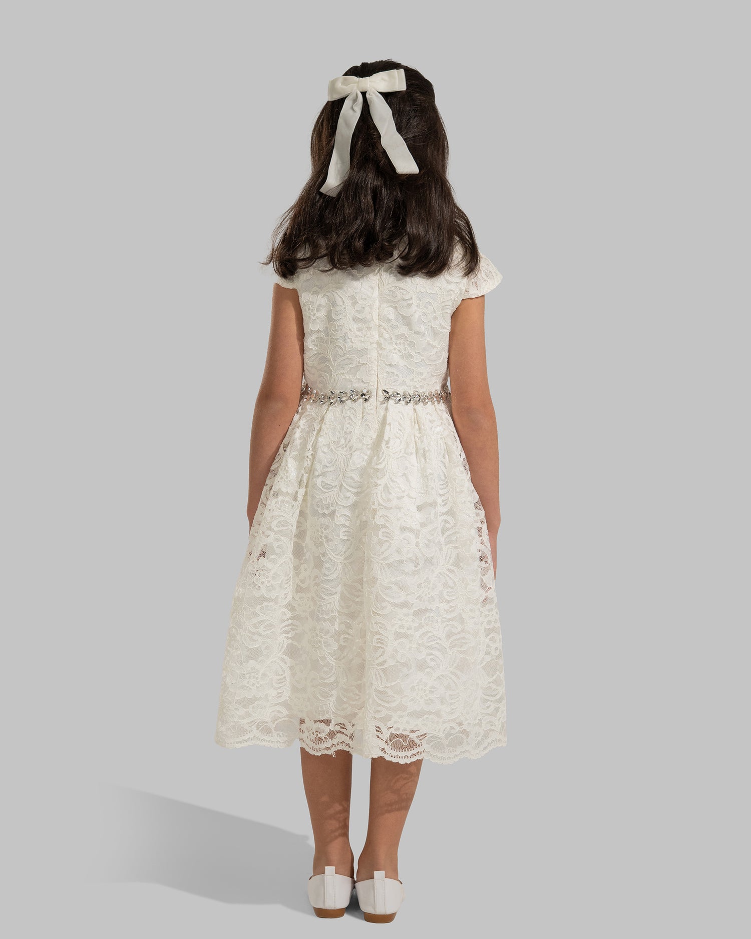 An elegant white floral lace dress featuring short capped sleeves
