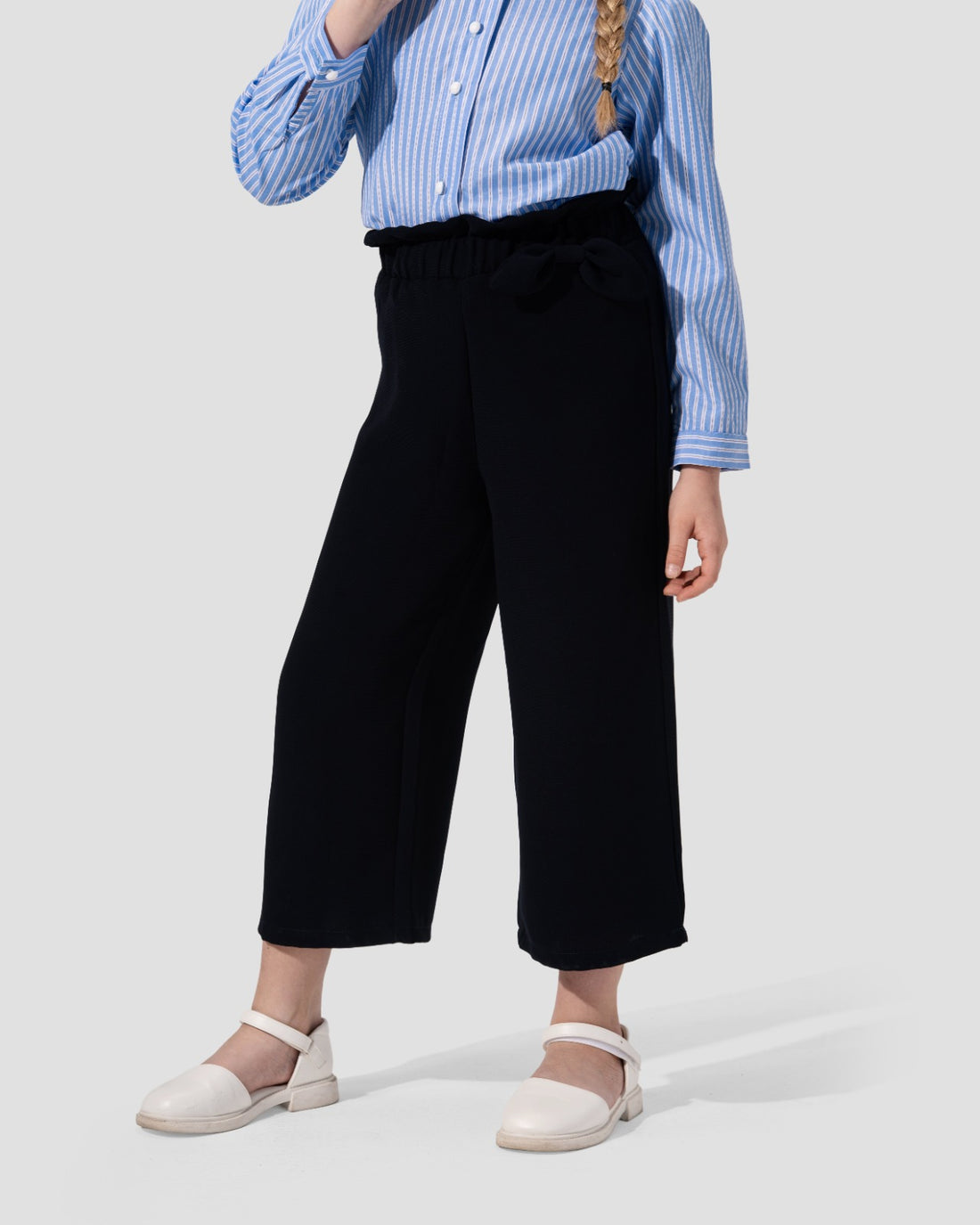 Wide-leg culotte trousers in navy blue with a high waist and side tie detail.