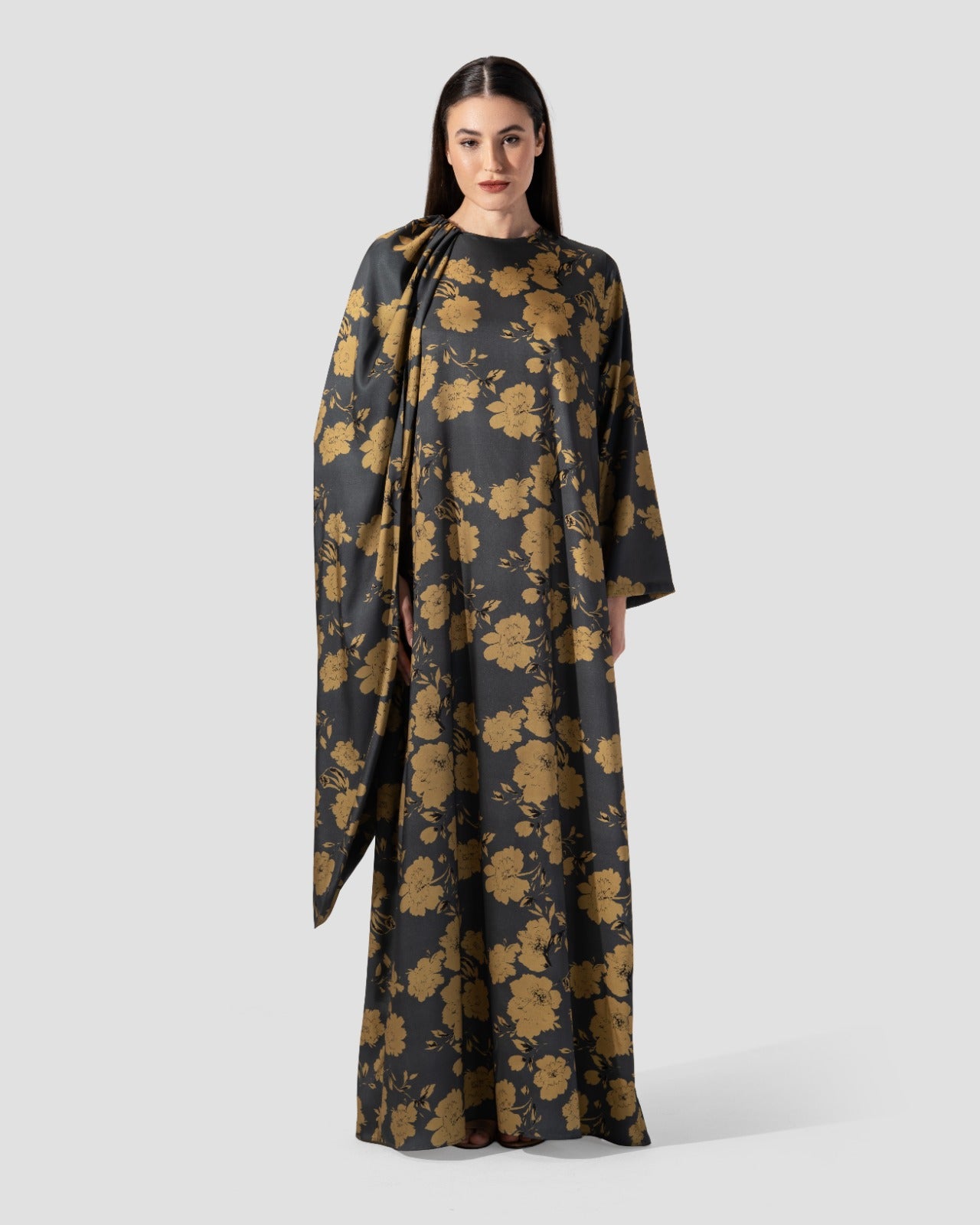 loose dress with a floral print of golden flowers .